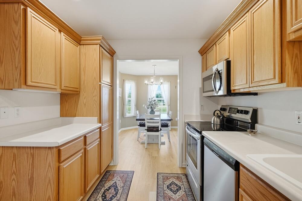 N16W26512 Golf View Lane, Unit E Pewaukee, WI 53072 - Photo 4 of 36 Kitchen into Dining Room