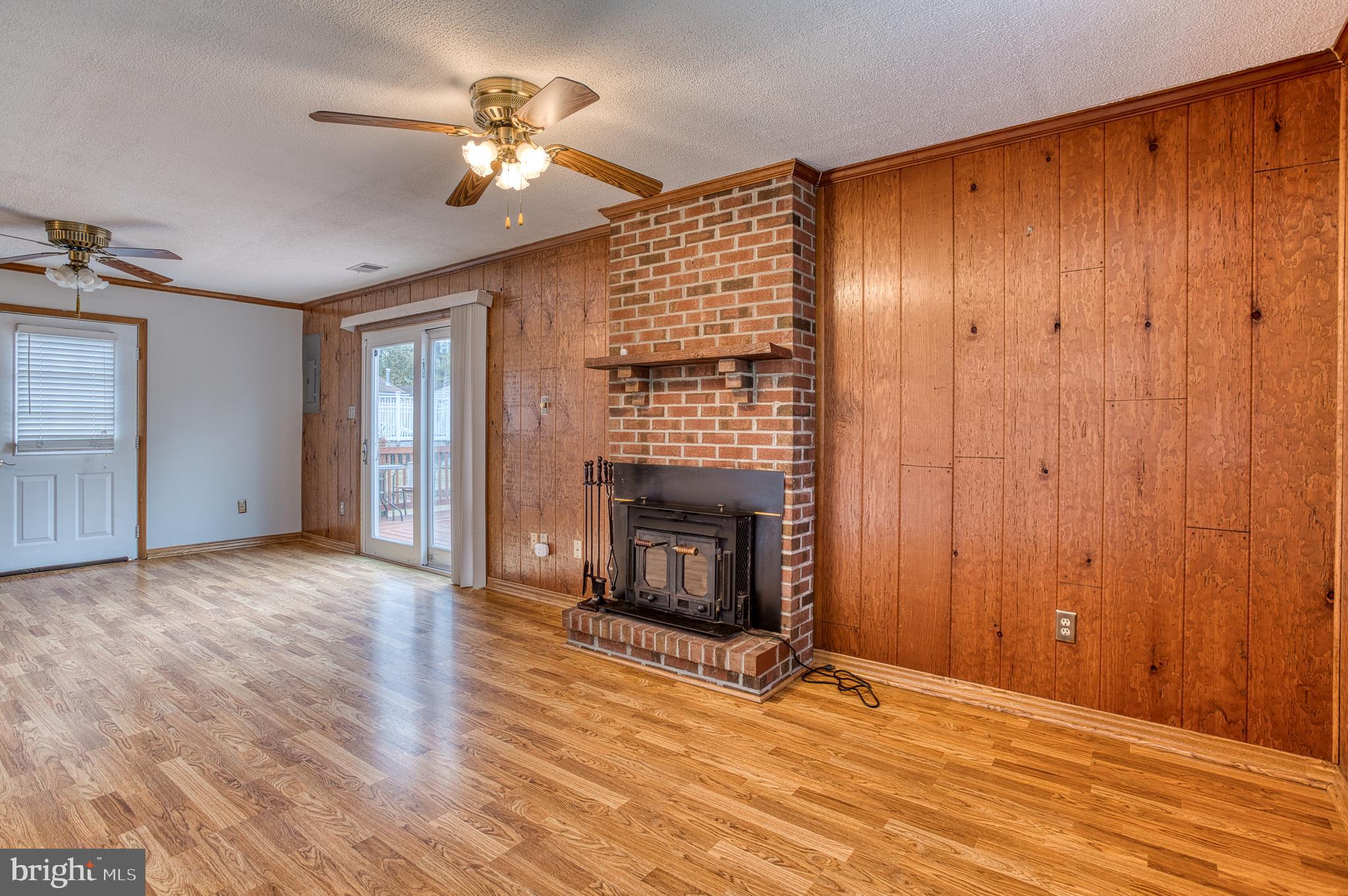 3565 Maple Street Dumfries, VA 22026 - Photo 14 of 36 a view of an empty room with wooden floor fireplace and a window