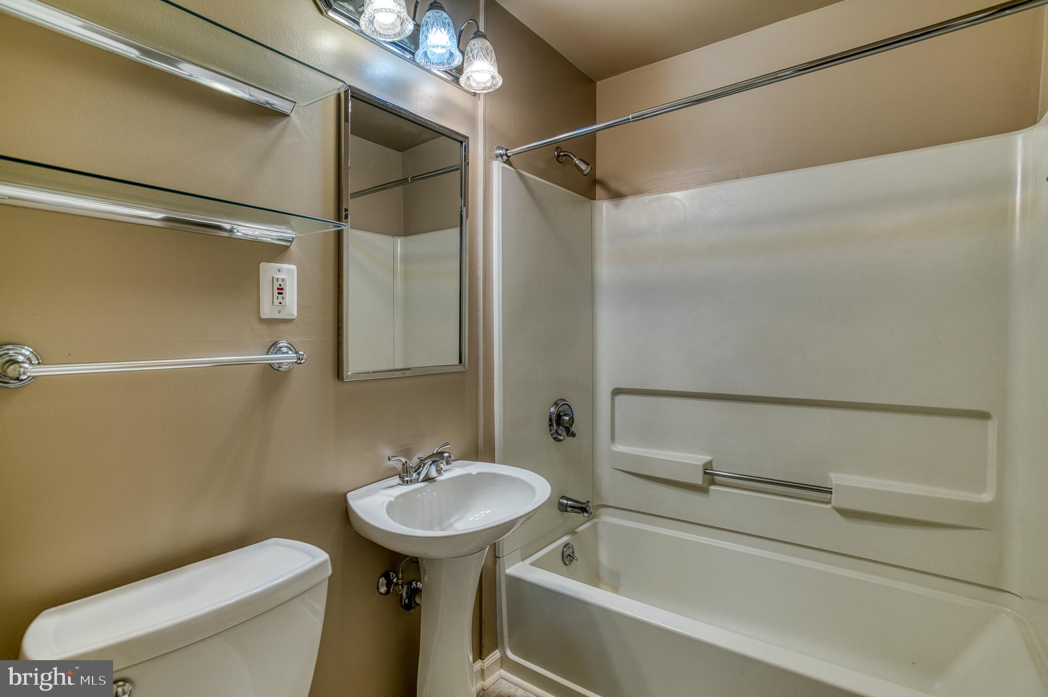 3565 Maple Street Dumfries, VA 22026 - Photo 18 of 36 a bathroom with a sink a toilet and shower