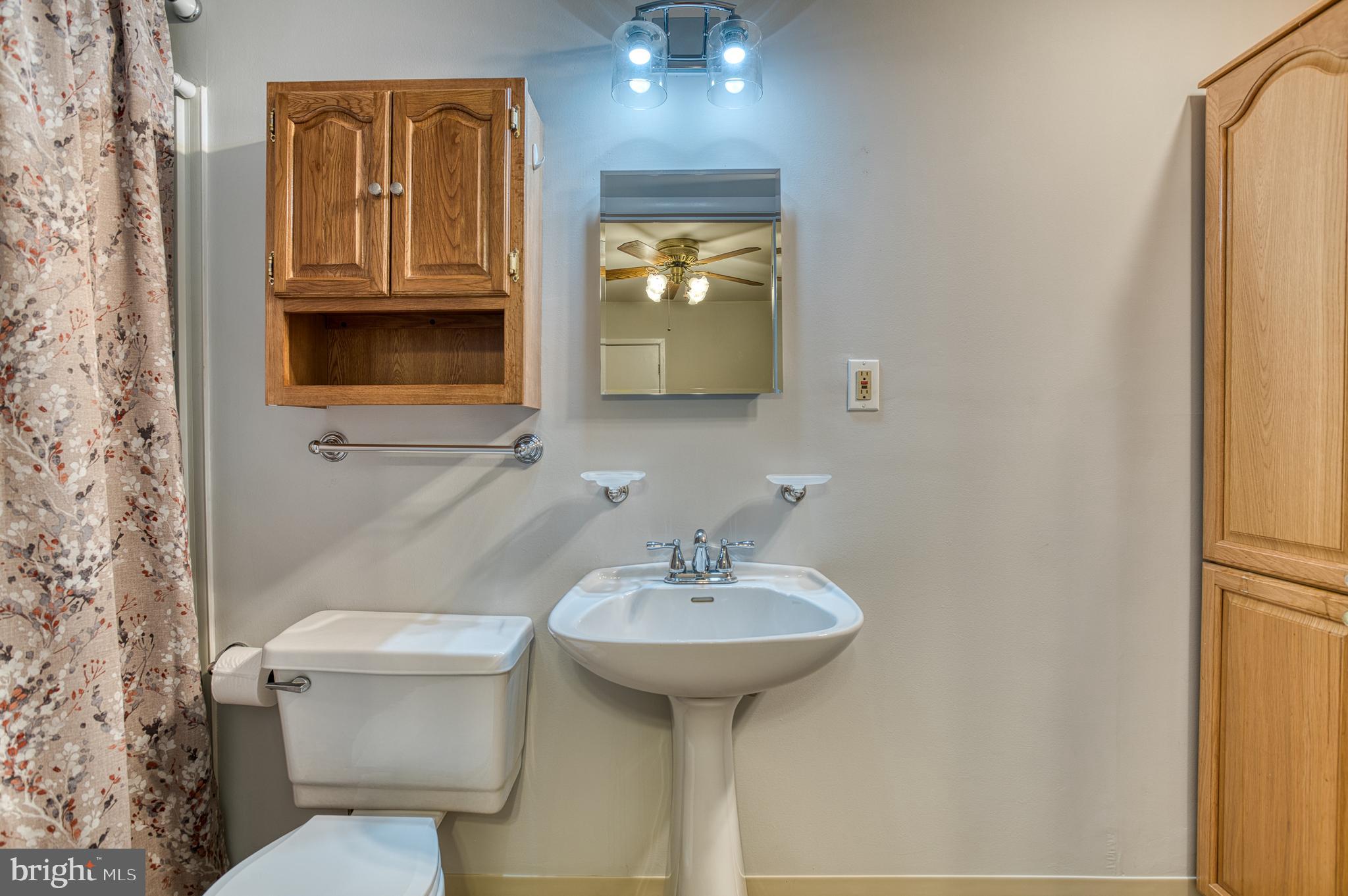 3565 Maple Street Dumfries, VA 22026 - Photo 21 of 36 a bathroom with a toilet sink and mirror