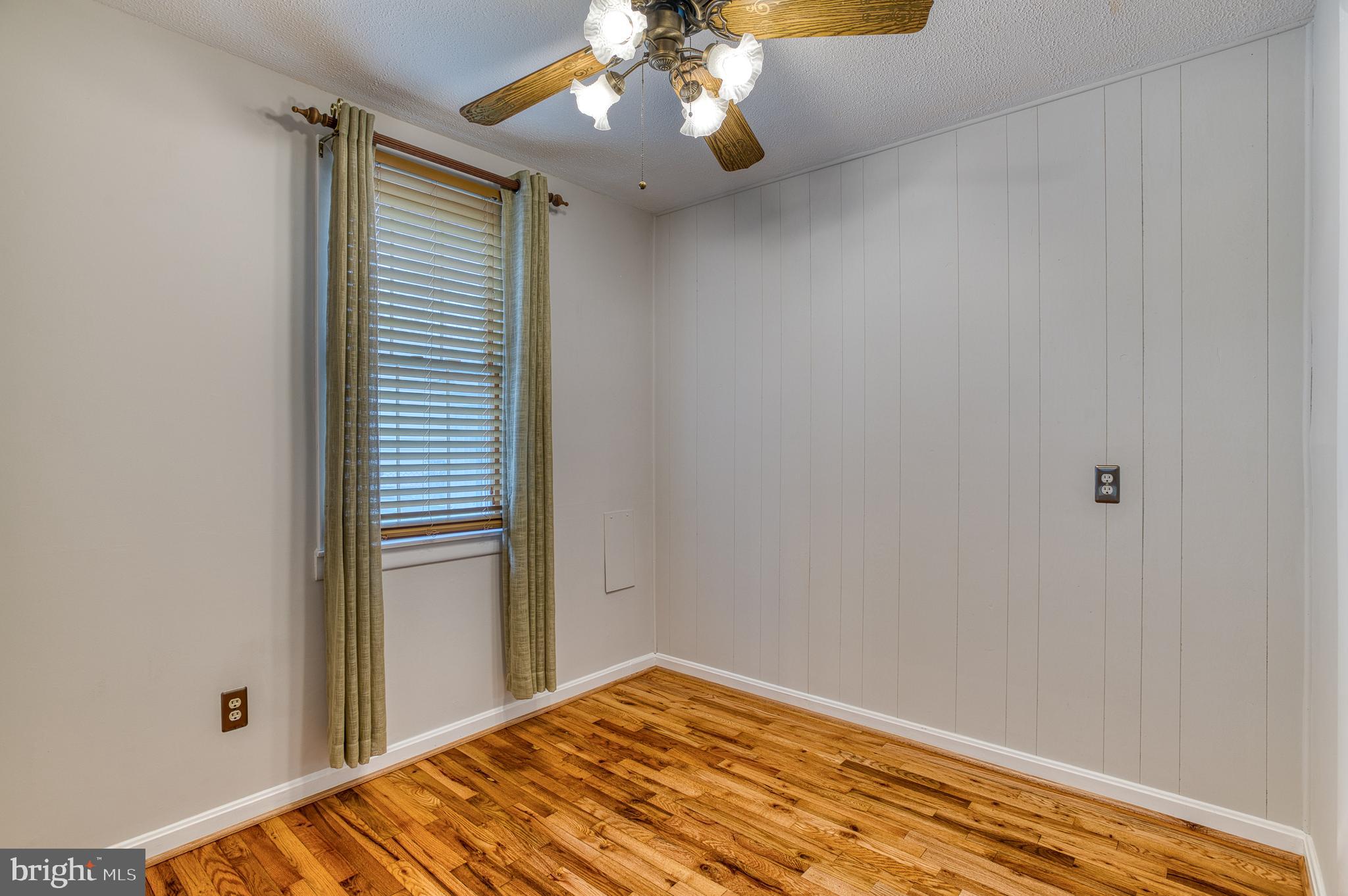 3565 Maple Street Dumfries, VA 22026 - Photo 23 of 36 a view of a bedroom with a chandelier fan and a window