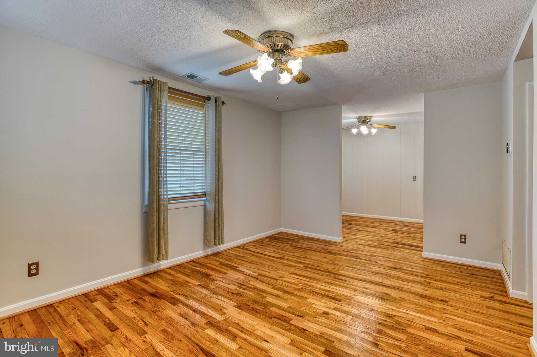 3565 Maple Street Dumfries, VA 22026 - Photo 24 of 36 a view of a livingroom with a ceiling fan and window
