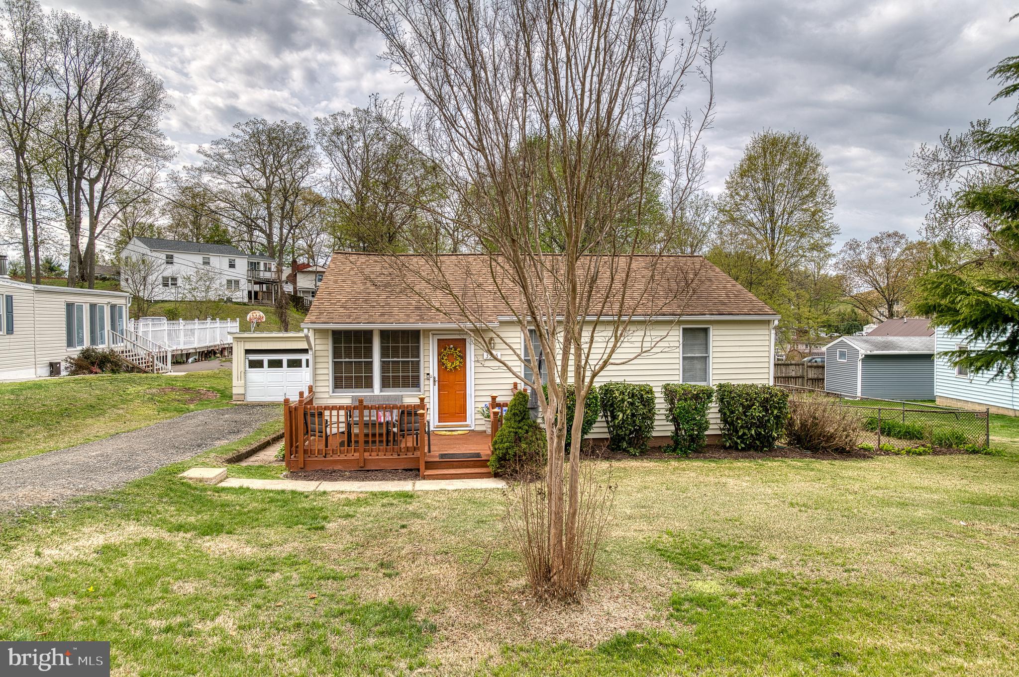 3565 Maple Street Dumfries, VA 22026 - Photo 25 of 36 a front view of a house with a yard table and chairs