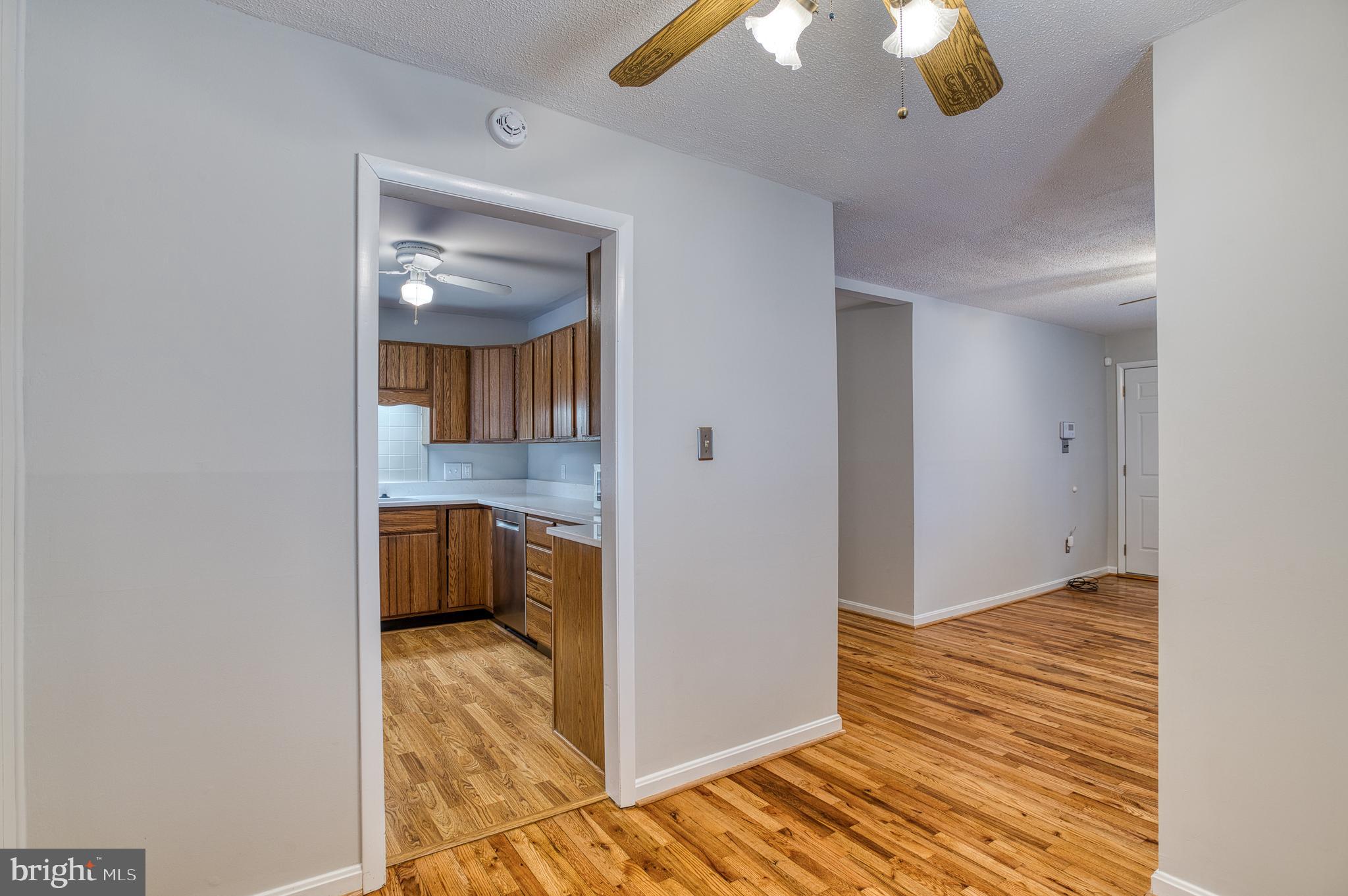 3565 Maple Street Dumfries, VA 22026 - Photo 7 of 36 a view of a kitchen from a hallway