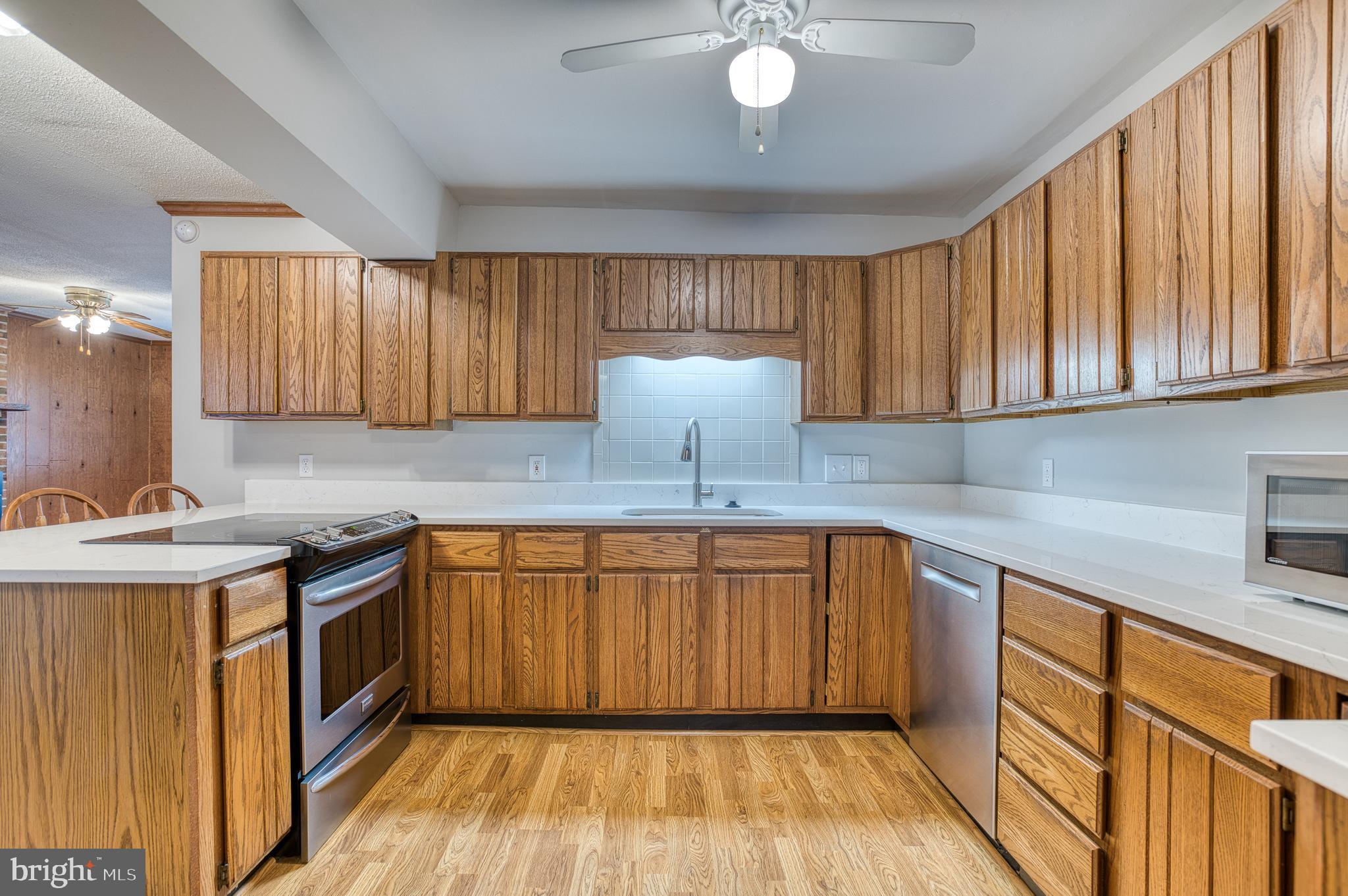 3565 Maple Street Dumfries, VA 22026 - Photo 8 of 36 a kitchen with stainless steel appliances granite countertop a sink and cabinets