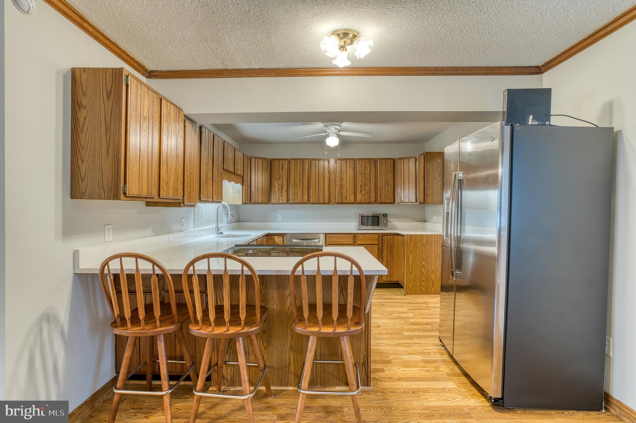 3565 Maple Street Dumfries, VA 22026 - Photo 10 of 36 a view of a kitchen with kitchen island dining table and stainless steel appliances