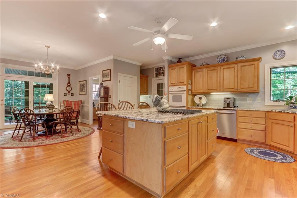 Additional view of kitchen island and breakfast nook that leads to huge screened porch.