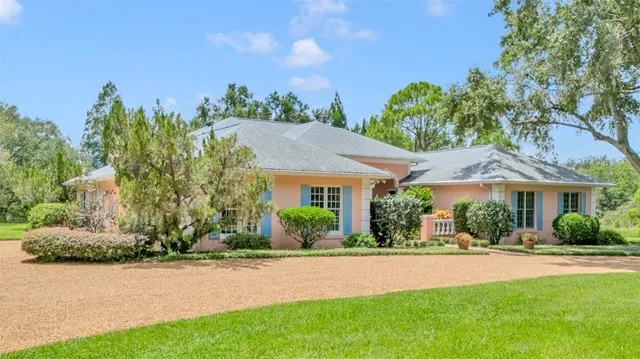 a front view of a house with a yard and potted plants
