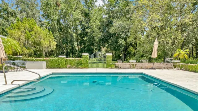 a view of a hallway with wooden floor and dining room