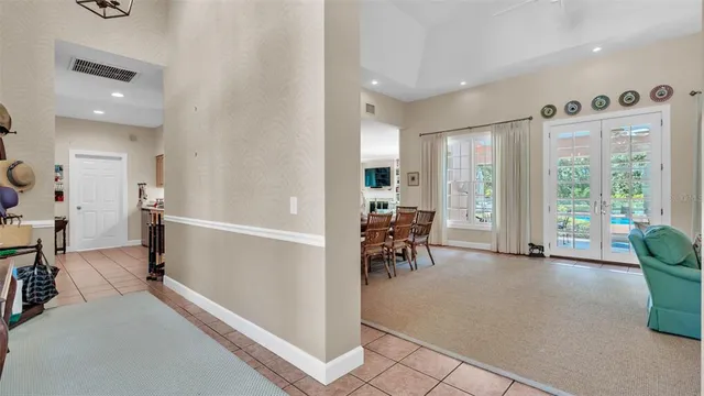 a view of a dining room with furniture and chandelier