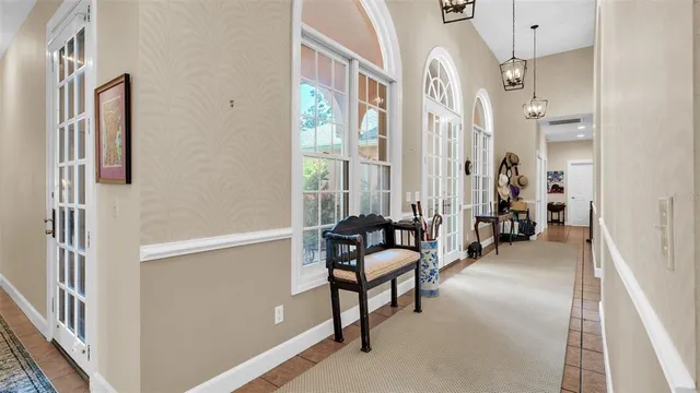 a living room with furniture kitchen view and a large window