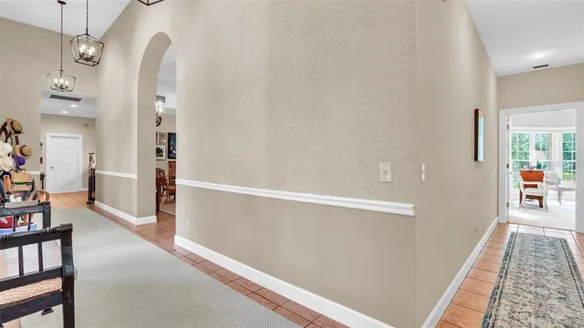 a living room with furniture a fireplace and large windows