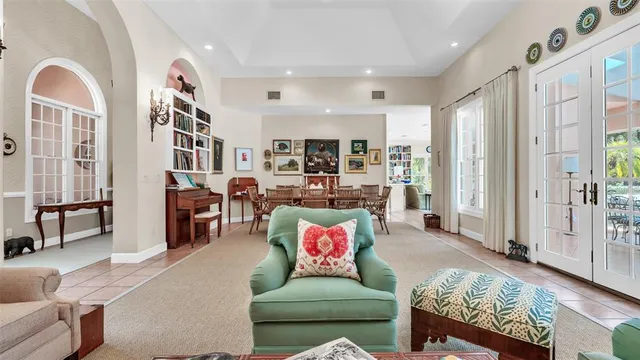 a living room with furniture and a floor to ceiling window