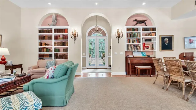 a view of a dining room with furniture a chandelier and wooden floor