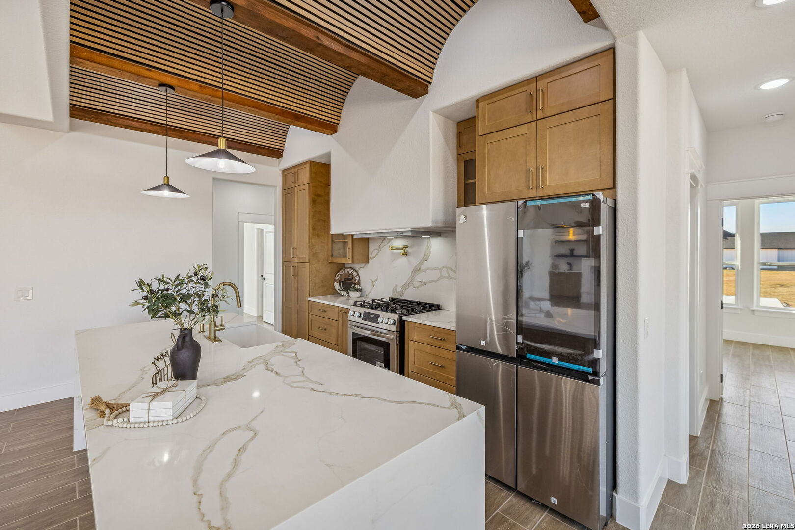 187 Hidden Ranch Court Floresville, TX 78114 - Photo 14 of 37 a kitchen with a refrigerator and a sink