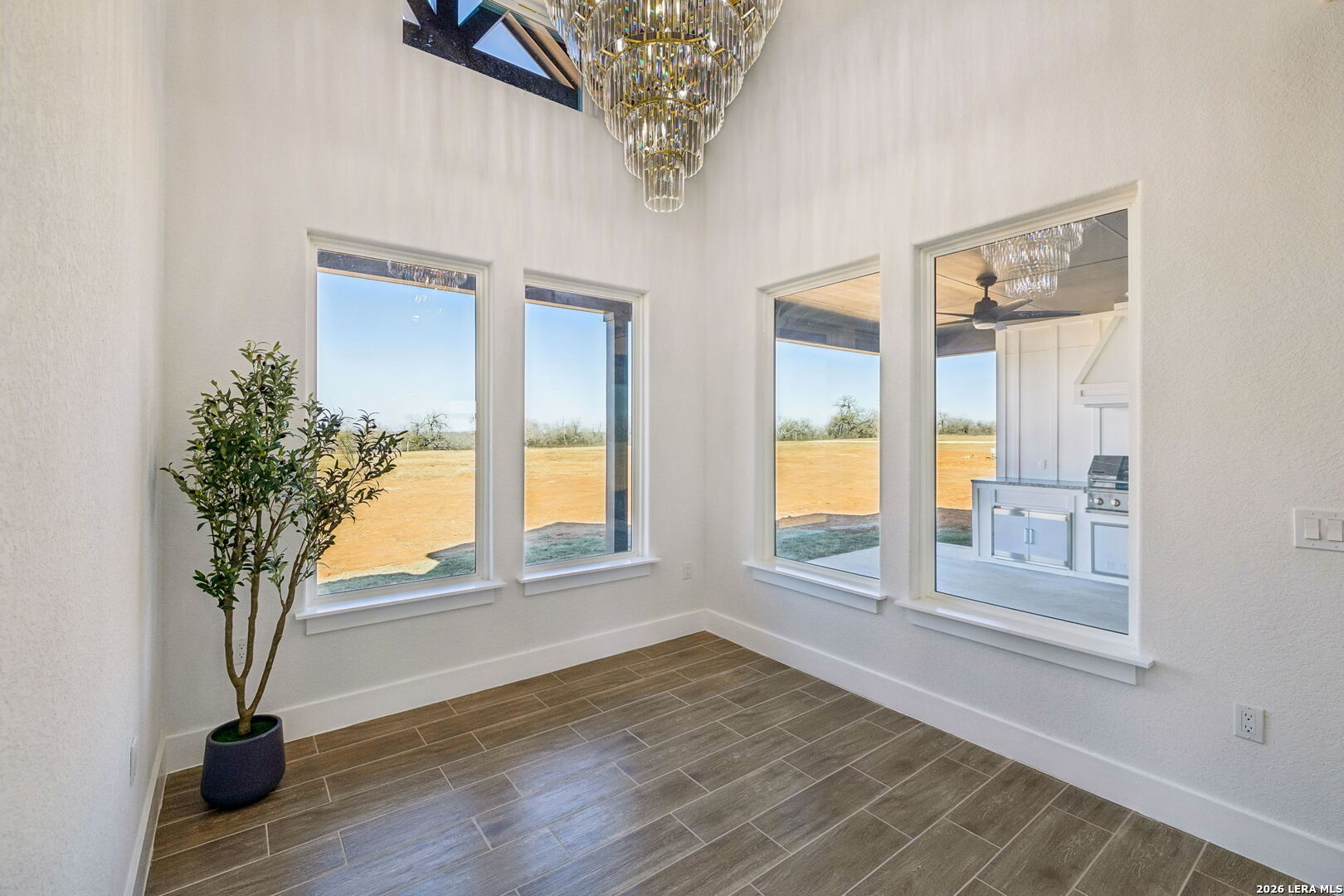 187 Hidden Ranch Court Floresville, TX 78114 - Photo 15 of 37 a view of an empty room with a window and wooden floor