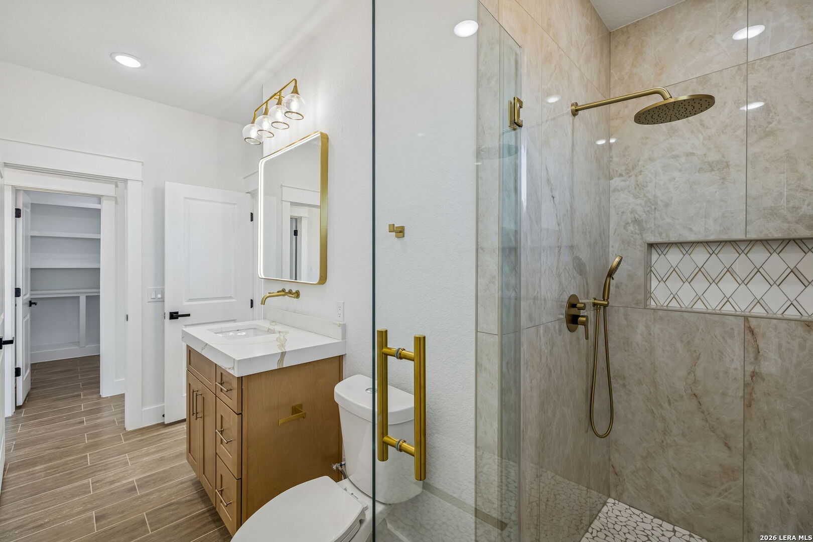 187 Hidden Ranch Court Floresville, TX 78114 - Photo 20 of 37 a spacious bathroom with a sink a toilet and shower