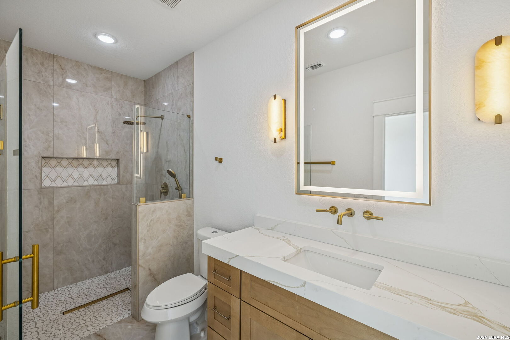 187 Hidden Ranch Court Floresville, TX 78114 - Photo 24 of 37 a bathroom with a sink a toilet and shower