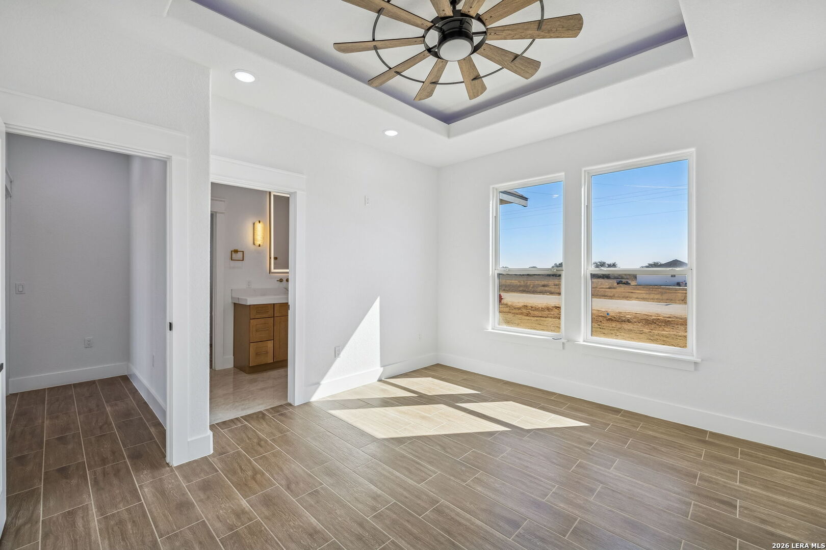 187 Hidden Ranch Court Floresville, TX 78114 - Photo 25 of 37 a view of an empty room with wooden floor and a window