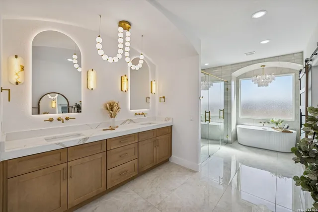 a bathroom with a tub a sink and mirror