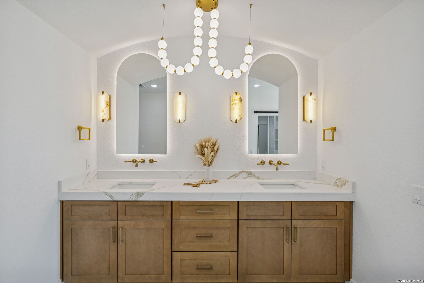 187 Hidden Ranch Court Floresville, TX 78114 - Photo 32 of 37 a bathroom with a double vanity sink and a mirror
