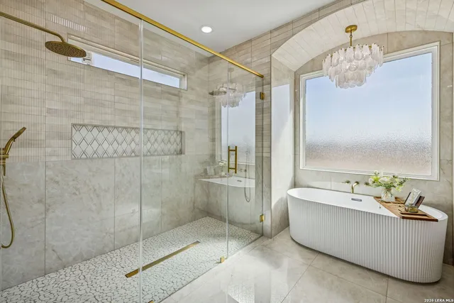 a large kitchen with stainless steel appliances granite countertop a stove and a large window