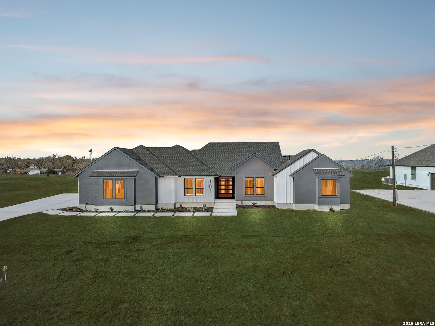 187 Hidden Ranch Court Floresville, TX 78114 - Photo 37 of 37 a view of a big house with a big yard and large trees
