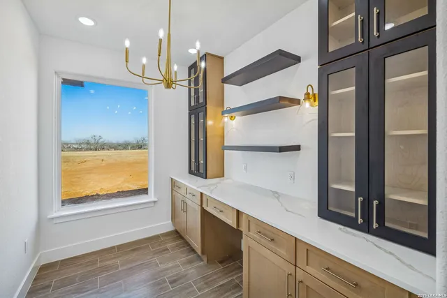 a kitchen with stainless steel appliances granite countertop a refrigerator a oven and a sink with wooden floor