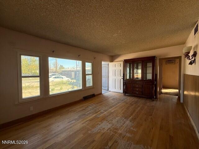 1809 K Street Sparks, NV 89431 - Photo 13 of 18 a view of an empty room with a window and wooden floor