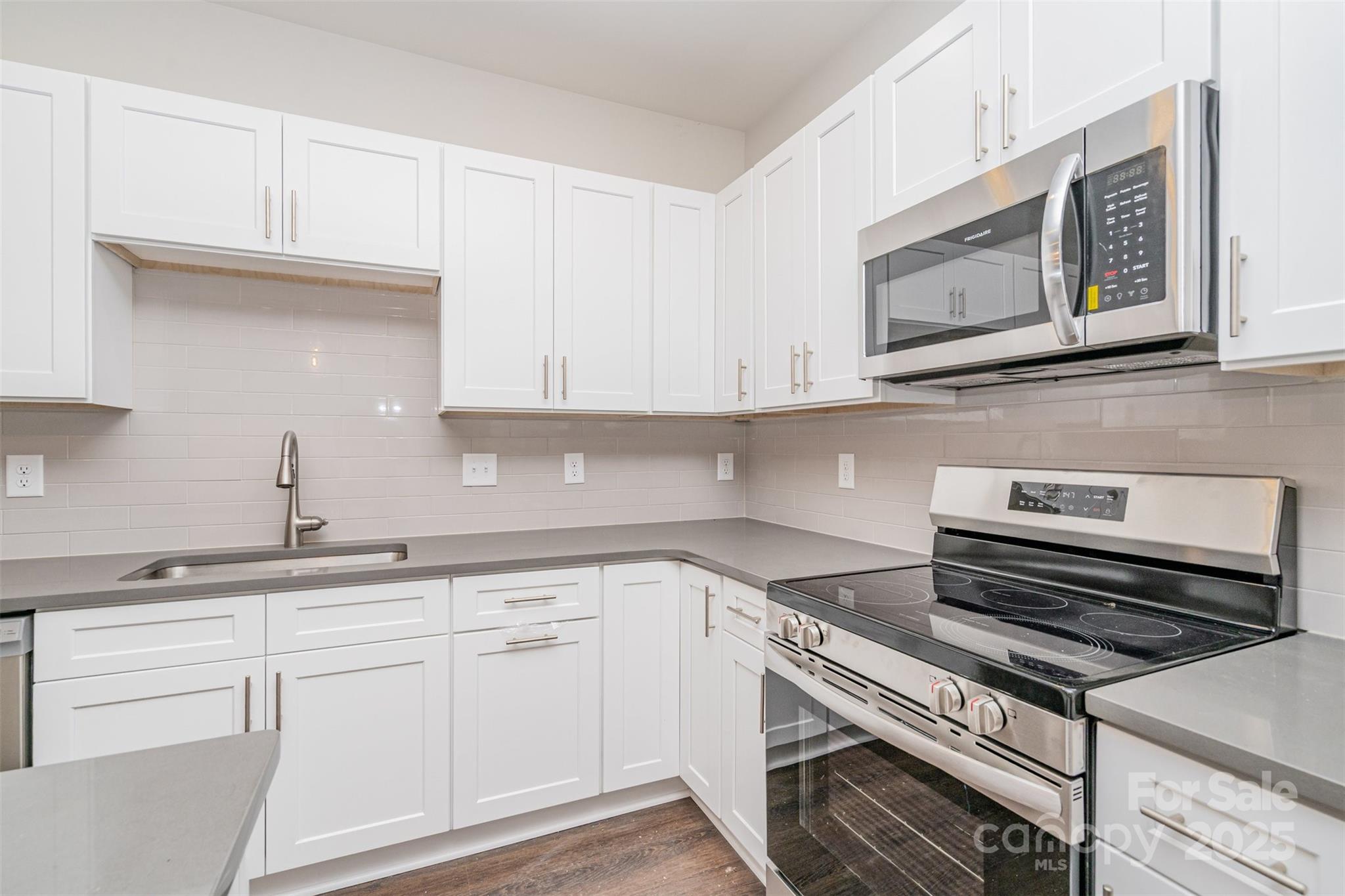 7312 Boswell Road Charlotte, NC 28215 - Photo 13 of 33 a kitchen with white cabinets and appliances