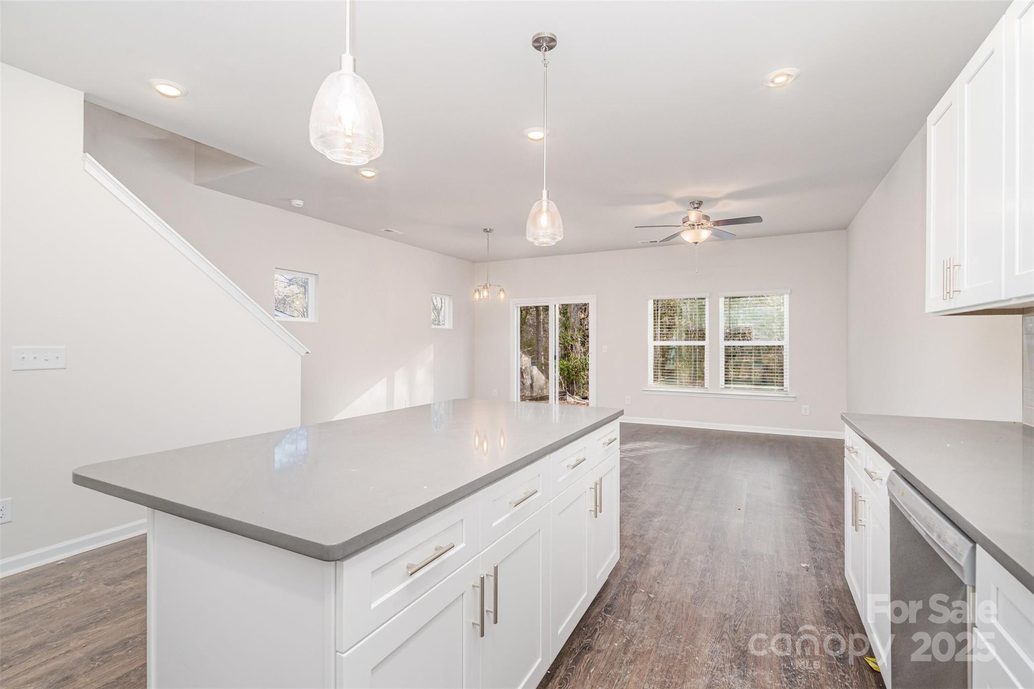 7312 Boswell Road Charlotte, NC 28215 - Photo 14 of 33 an open kitchen with a sink and dishwasher with wooden floor