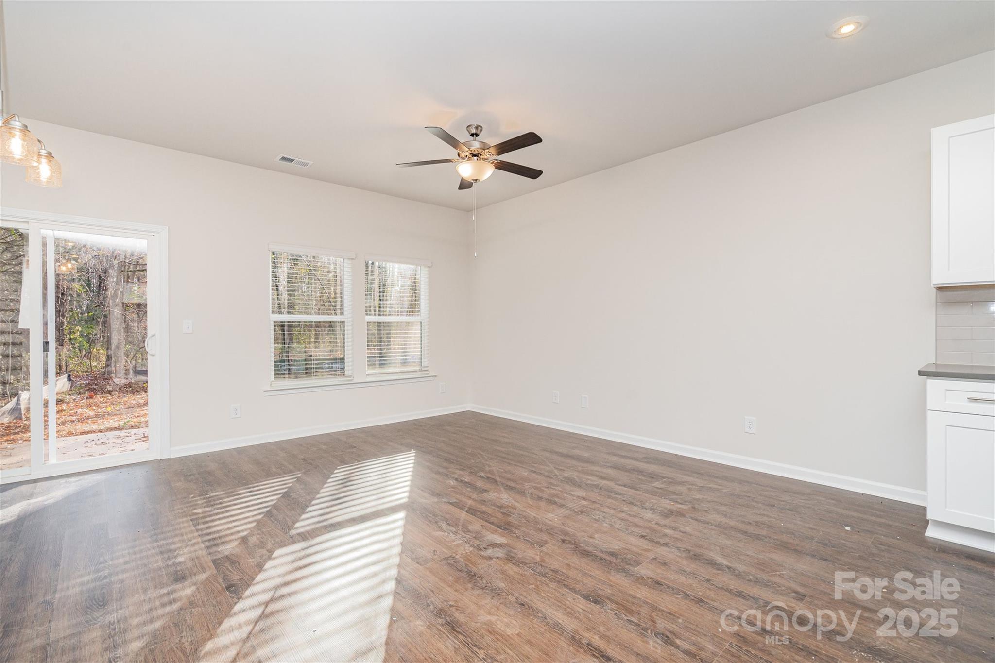 7312 Boswell Road Charlotte, NC 28215 - Photo 15 of 33 wooden floor in an empty room with a window