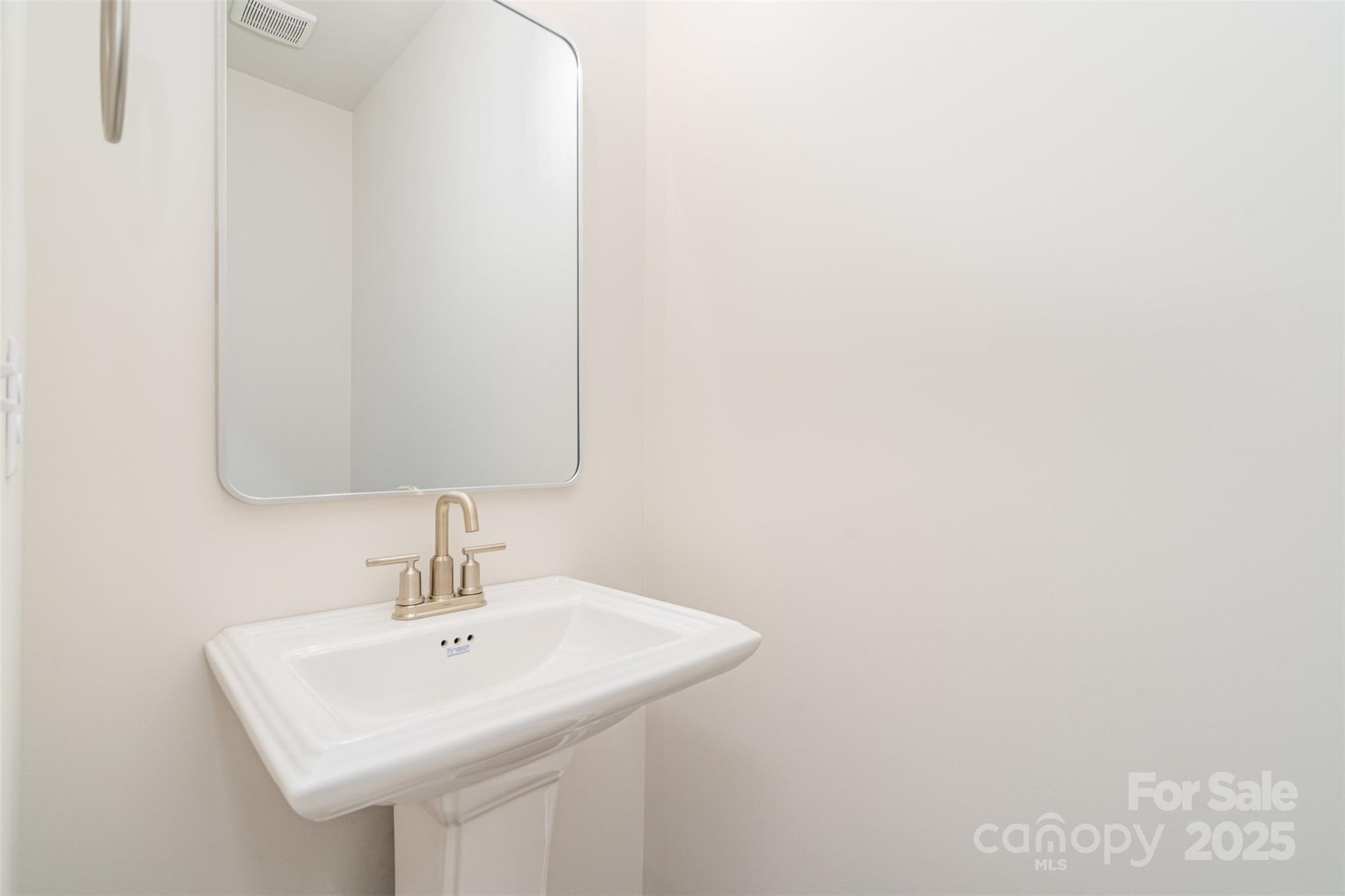 7312 Boswell Road Charlotte, NC 28215 - Photo 17 of 33 a bathroom with a sink and a mirror