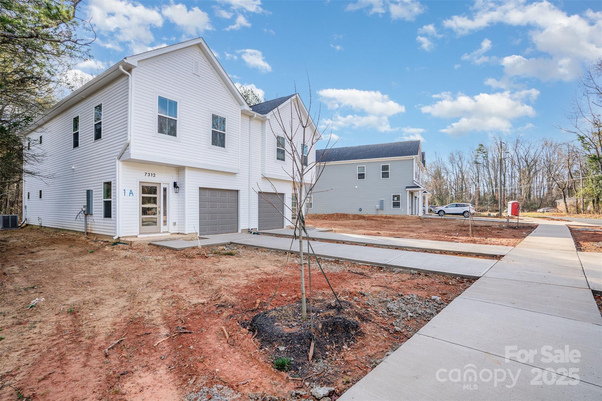 7312 Boswell Road Charlotte, NC 28215 - Photo 2 of 33 a front view of a house with a yard
