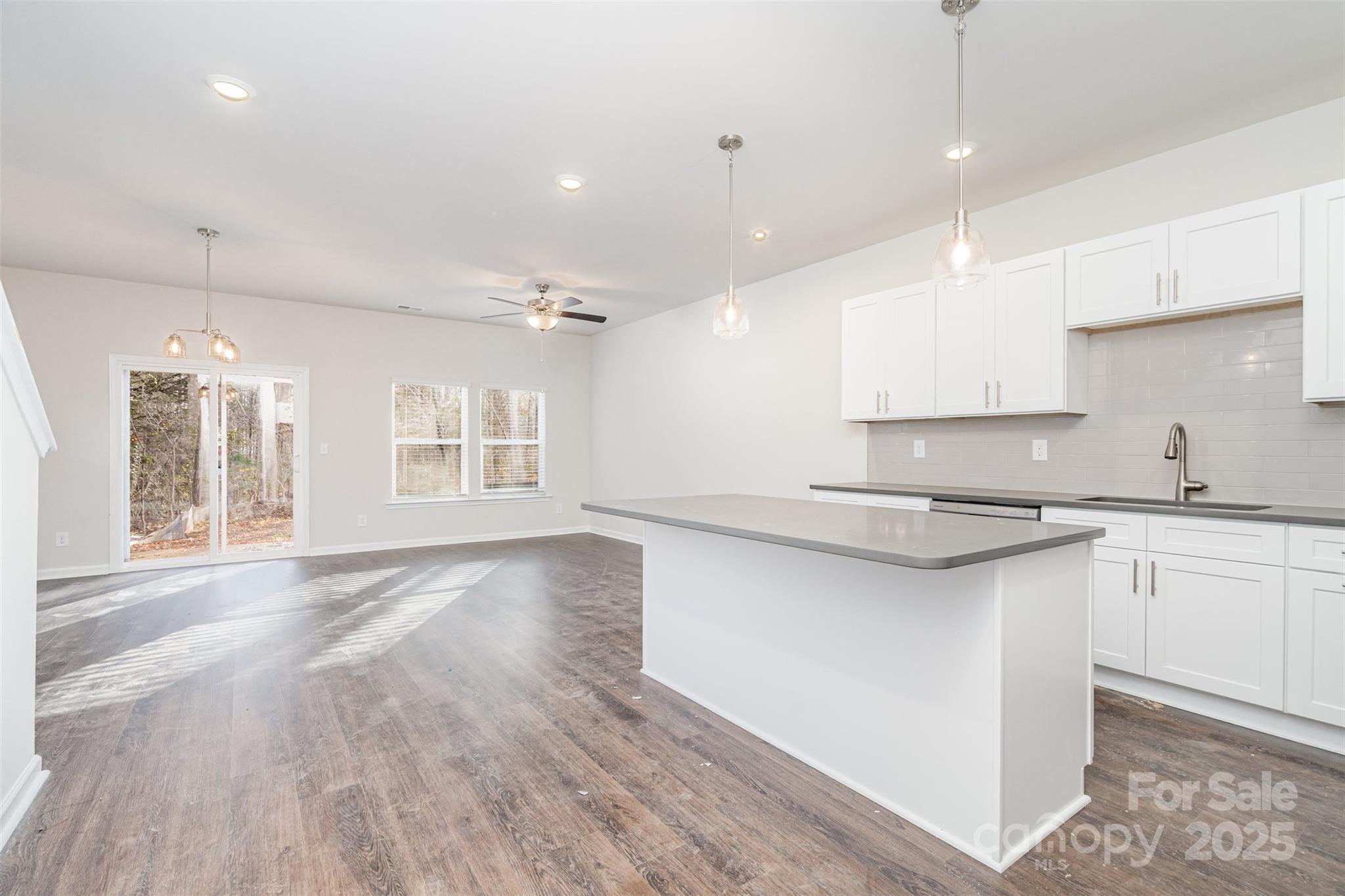 7312 Boswell Road Charlotte, NC 28215 - Photo 10 of 33 a large kitchen with granite countertop a sink window and a counter top space