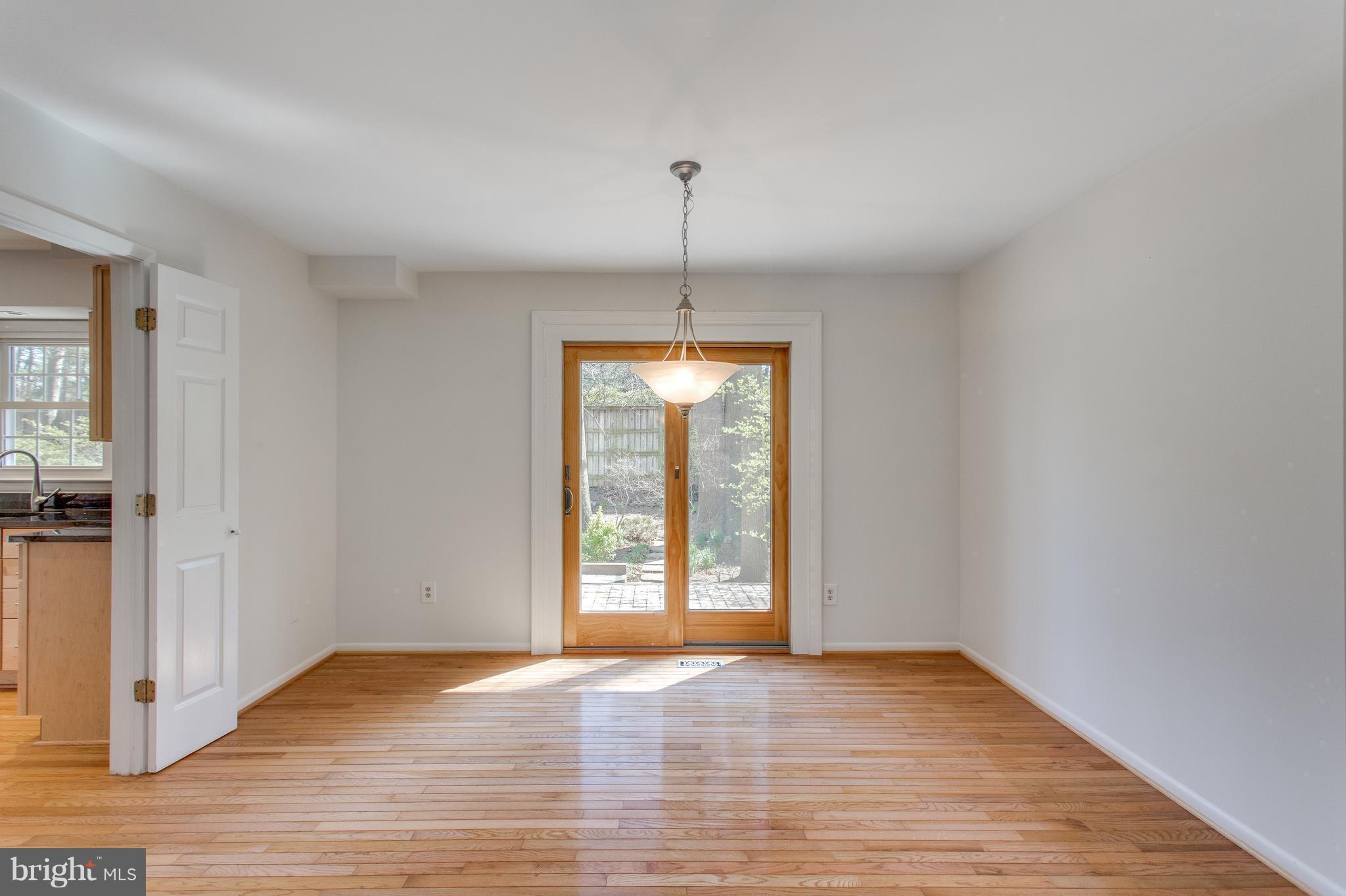 9860 Natick Road Burke, VA 22015 - Photo 7 of 30 Dining Room has wood doors to the back patio