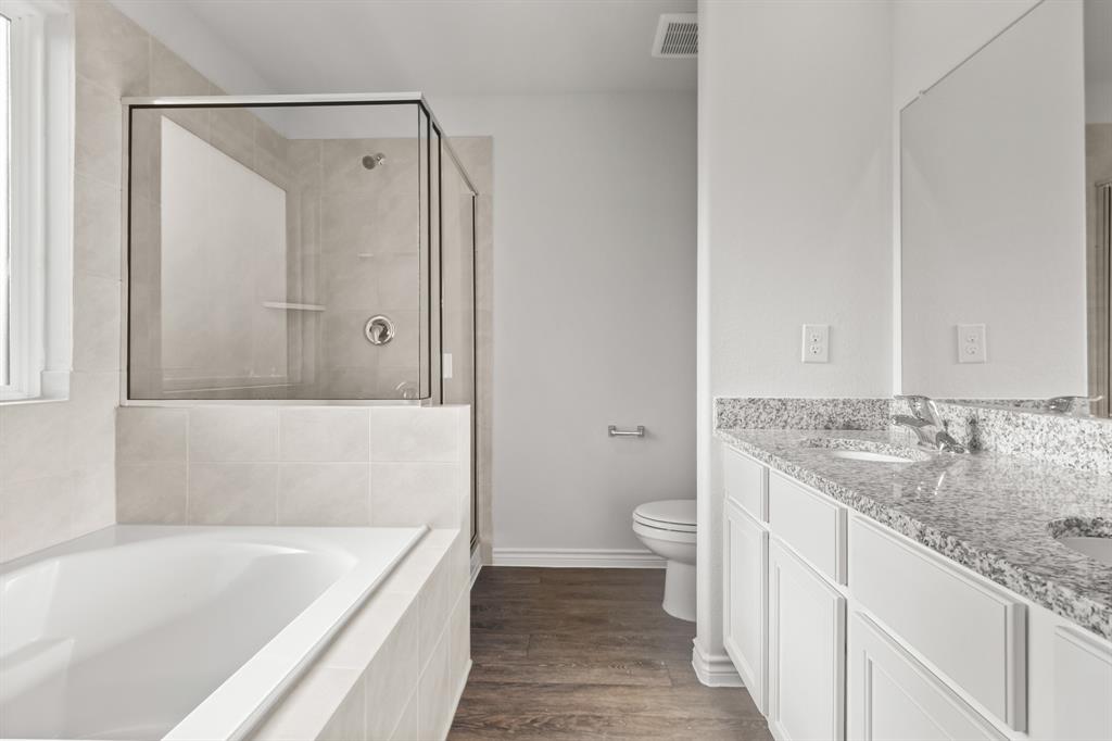 1609 Romans Road Ennis, TX 75119 - Photo 10 of 17 a bathroom with a granite countertop sink a toilet and bathtub
