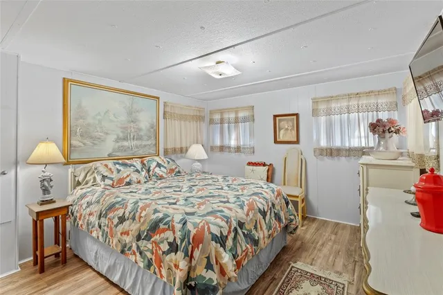 a bed sitting in a bedroom next to a window