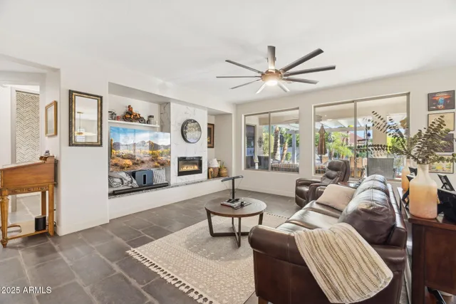 a view of a hallway to a bedroom with windows