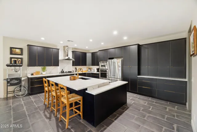 a view of a dining room and livingroom with furniture wooden floor a chandelier