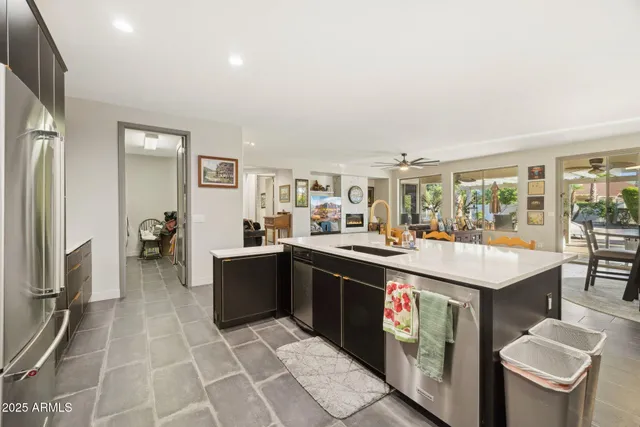 a large kitchen with a large counter top appliances and cabinets