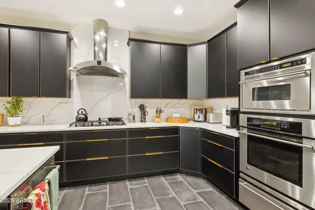 a kitchen with a sink stove and cabinets