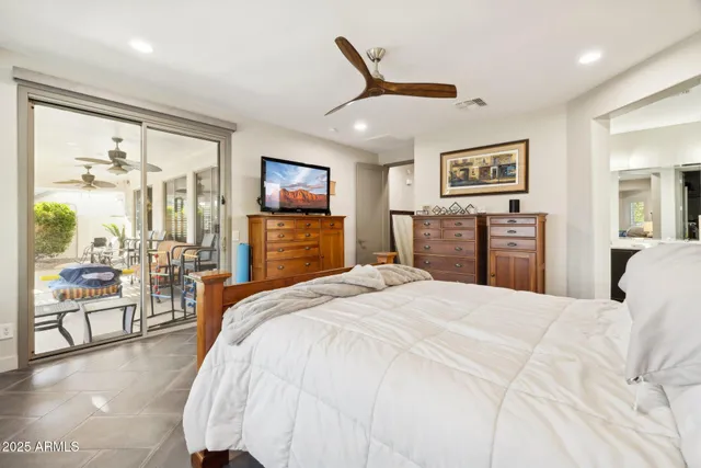 a spacious bedroom with a bed and a cabinets