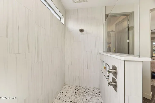 a bathroom with a double vanity sink and a mirror
