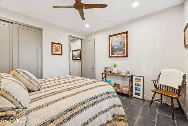 a bedroom with a bed and chair