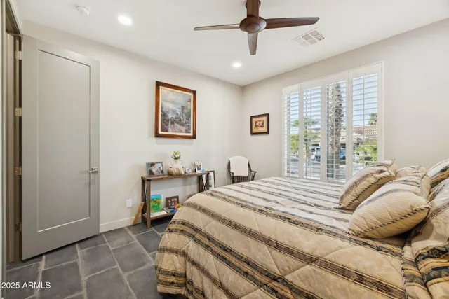 a bedroom with a bed and a chair