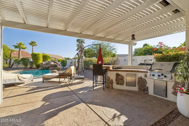 a living room with patio furniture and a floor to ceiling window