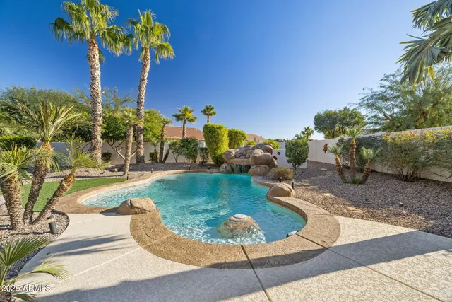 a view of a patio with a table chairs and a backyard