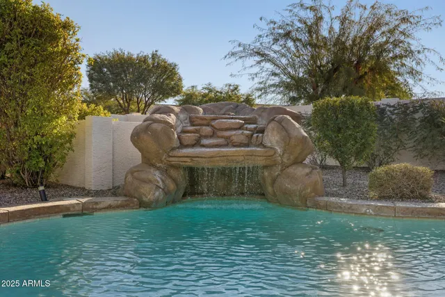 a view of a swimming pool and lounge chairs