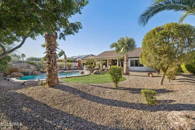 a view of a backyard with table and chairs and wooden fence